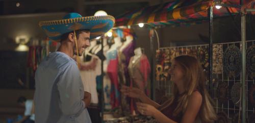 a man wearing a sombrero standing next to a woman at Occidental Costa Cancún - All Inclusive in Cancún