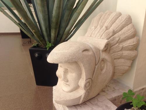 a statue of a head with a hat on at Hotel Yaocalli in San Martín de las Pirámides