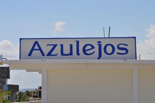 a sign on top of a building at Hotel Azulejos in Chachalacas