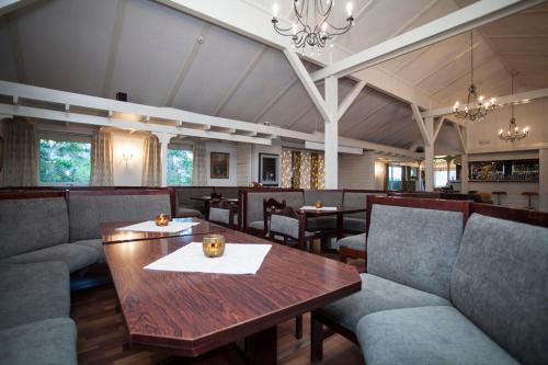 a restaurant with a wooden table and chairs at Stetind Hotel in Kjøpsvik
