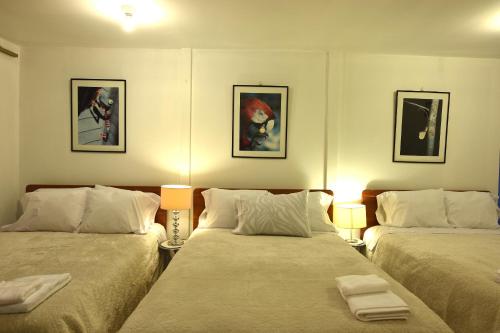 En eller flere senger på et rom på Cusco Retreat