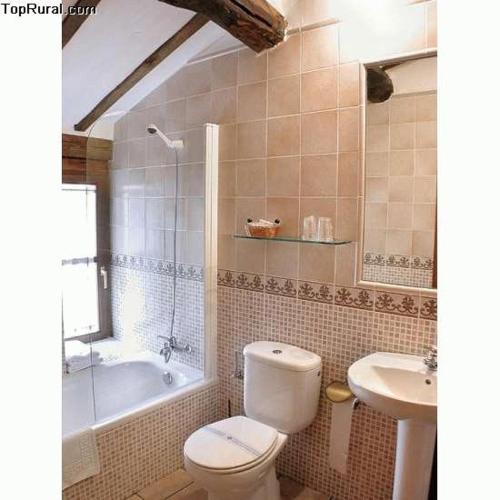 a bathroom with a toilet and a tub and a sink at La Cuculla in Ezcaray