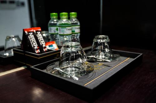 a tray with two glasses and bottles on a table at Royal Quang Binh Hotel in Dong Hoi