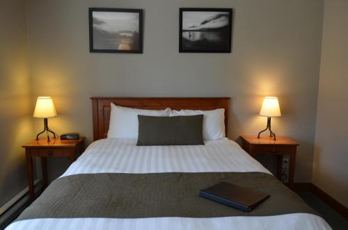 a bedroom with a bed with a book on it at Howe Sound Inn & Brewing Company in Squamish