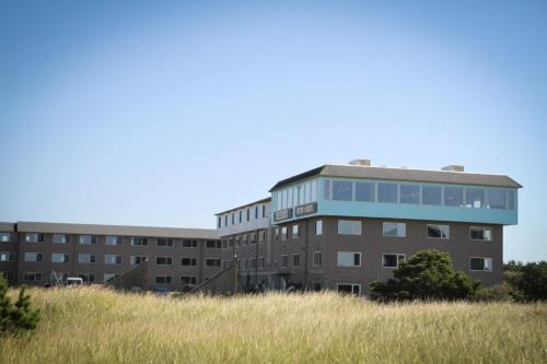 長灘的住宿－艾迪麗芙特酒店，蓝色屋顶和高大的草的办公楼