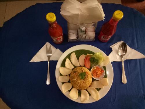 a plate of food sitting on a blue table at Taman Ayu Legian Hotel in Legian