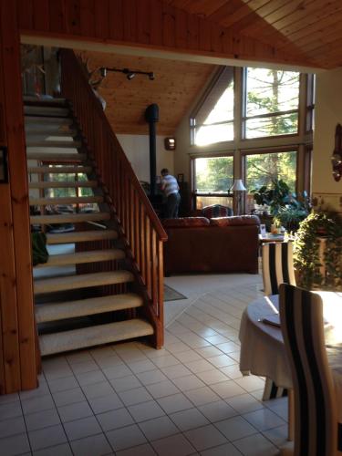 a living room with a staircase in a house at End of the road B & B in Cranbrook
