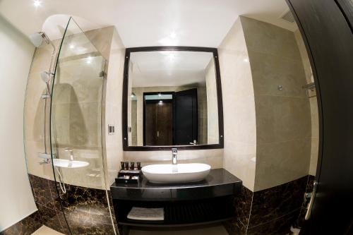 a bathroom with a sink and a mirror at Royal Quang Binh Hotel in Dong Hoi