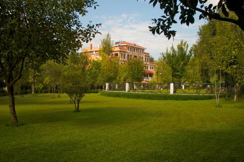 a green park with a building in the background at Park Village Resort by KGH Group in Kathmandu