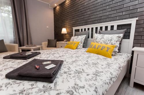 a bedroom with a bed with a happy tray on it at Grey Studio II in Wrocław