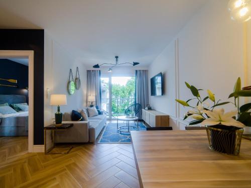 a living room with a couch and a table at Apartament Dwie Sosny Sunnyway in Ustronie Morskie
