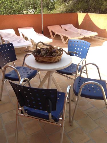 a table and chairs with a basket on a patio at Zhimbad B&B by the sea in Cala Ratjada