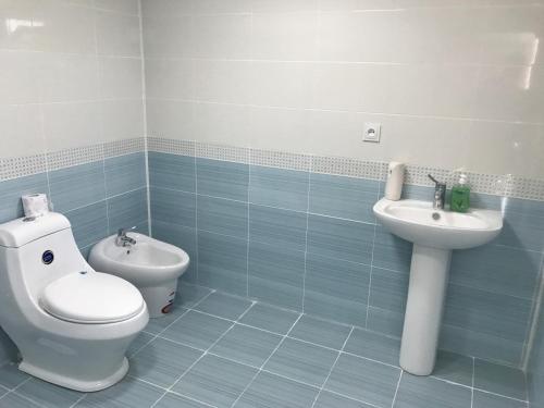 a bathroom with a toilet and a sink at Beaming_House in Sheki