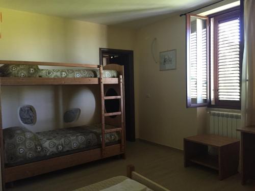 a room with two bunk beds and a window at Le Quattro Stagioni in Teano