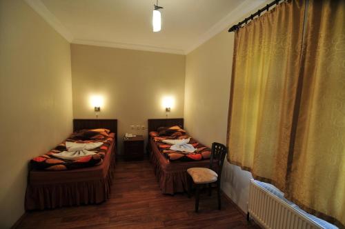 a room with two beds and a window at Hittite Houses in Bogazkale