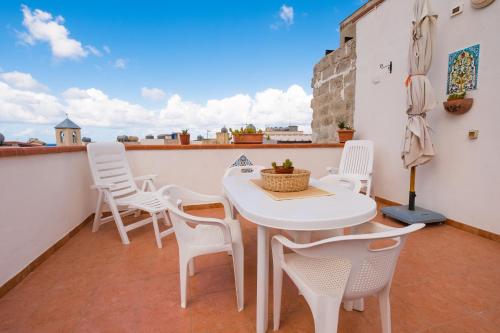 a white table and chairs on a balcony at Giulia e Pietro - Marettimo Apartments in Marettimo