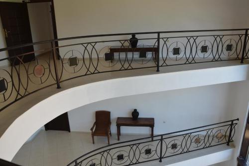 a staircase with a wrought iron railing and a table at Apartment on the Cliff Obzor in Obzor