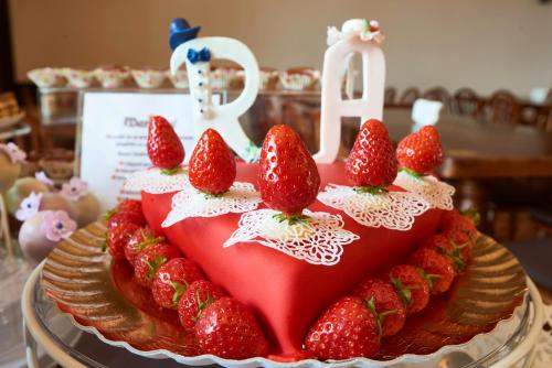 a birthday cake with strawberries on top of it at Resort Ambient in Cristian