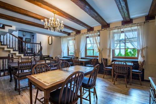 a dining room with tables and chairs and a chandelier at Resort Ambient in Cristian