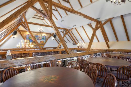 a dining room with wooden tables and chairs at Resort Ambient in Cristian