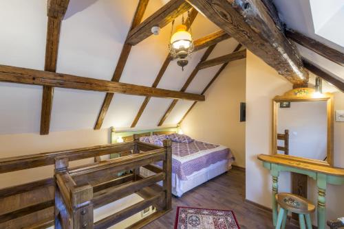 a bedroom with a bed in a room with wooden beams at Resort Ambient in Cristian