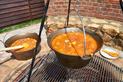two pots of food are cooking on a grill at Resort Ambient in Cristian