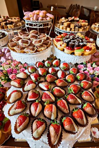 a display of cakes and pastries on a table at Resort Ambient in Cristian