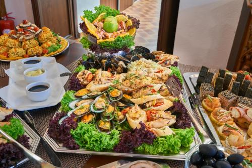 a buffet with many different types of food on a table at Resort Ambient in Cristian