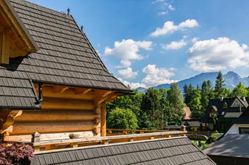 a log cabin balcony with a view of the mountains at Chaty Zakopane in Zakopane