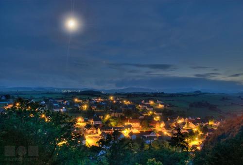 a town at night with the moon in the sky at Hotel Haus Wiesengrund in Hallenberg