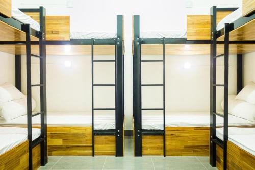 a room with three bunk beds in a hostel at Starfish Alley Hostel in Da Nang
