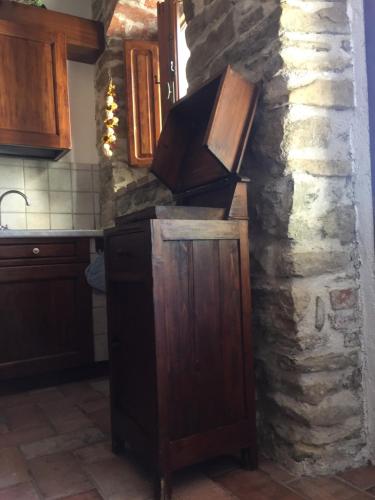 a kitchen with a stone wall and a stove at Casale degli ulivi in Gualdo Tadino