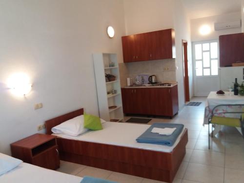 a small room with a bed and a kitchen at Apartments Boris in Omiš
