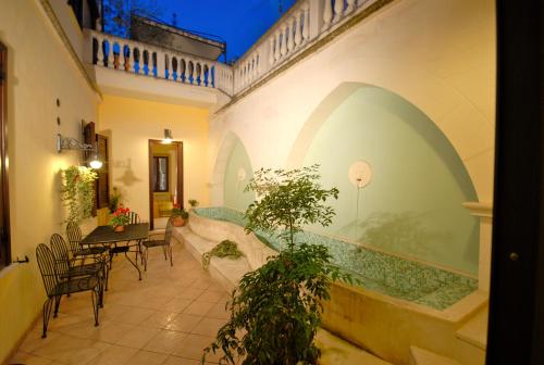 a building with a patio with a table and chairs at Sei Stelle in Sulmona