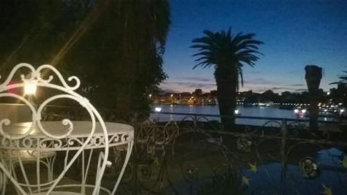 a table with a view of a river at night at Hotel Magllara in Sarandë