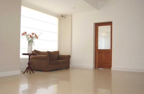 a living room with a couch and a door at Hotel Gran Madryn in Puerto Madryn