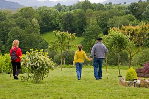 a group of three people walking in a field at Casa Rural Zigako Etxezuria in Ziga