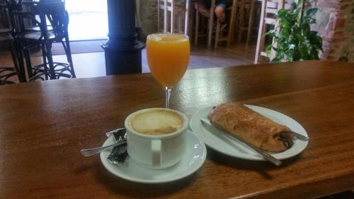 a cup of coffee and a cup of orange juice at Hostal Virgen de la Encina in Ponferrada
