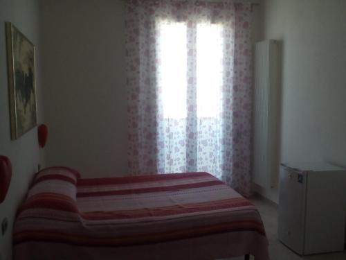 a bedroom with a bed in front of a window at Sister's love in Matera