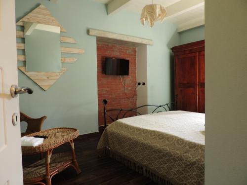 a bedroom with a bed and a staircase and a chair at B&B Danonna in Ittiri