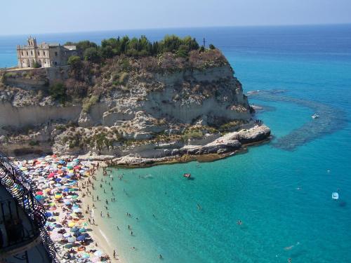 an aerial view of a beach with people in the water at I Soffitti Dimora Esclusiva in Tropea