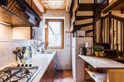 a small kitchen with a sink and a refrigerator at Villa Collebelvedere - Near Rome with Home Restaurant in Fara in Sabina