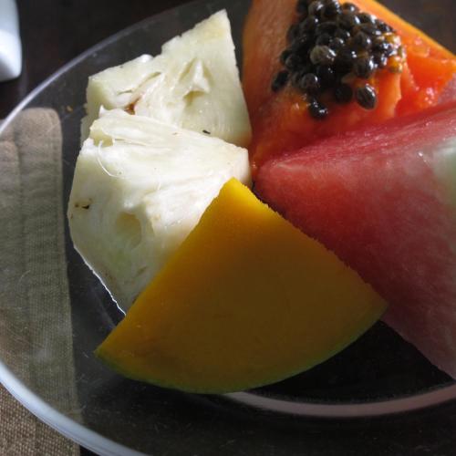 a plate of different types of cheese and fruit at Pousada Tranquila in Morro de São Paulo