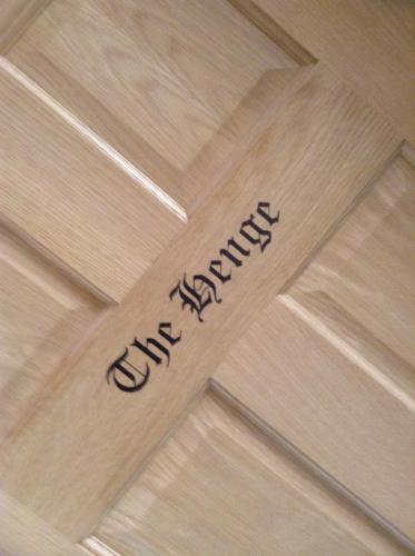 a sign on a wooden floor that says the answer at B&B Dorwyn Manor in Avebury