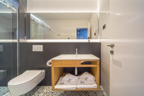 a bathroom with a sink and a toilet at Madrugada Old City in Stari Grad