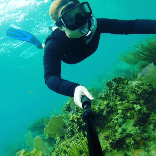 a woman is scuba diving in the ocean at Naniqui Cottage - Only Adults -Parking Golf Car Only in Culebra