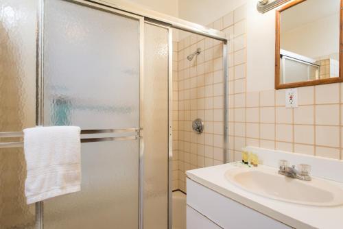 a bathroom with a shower and a sink at The Farrington Inn in Boston