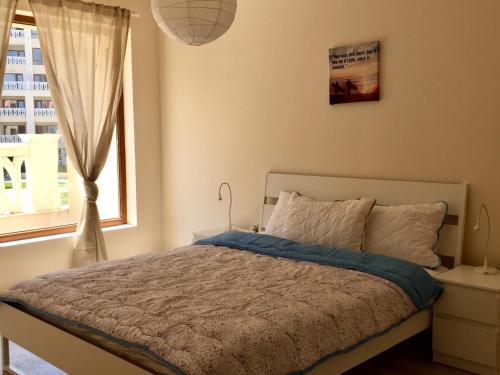 een slaapkamer met een groot bed en een raam bij PSB Apartments in South Bay Beach Residence in Varna