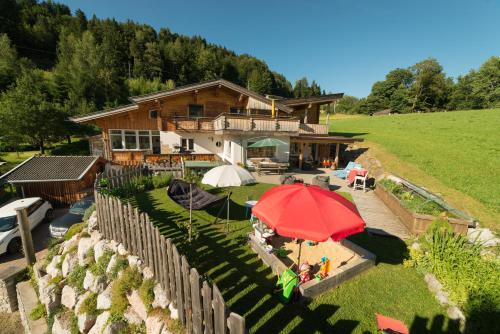 an aerial view of a house with a red umbrella at Haus Bergkraft in Leogang