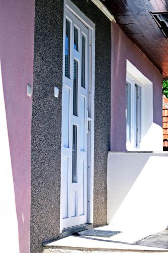 a white door on the side of a building at Apartmani Balibeg in Sarajevo